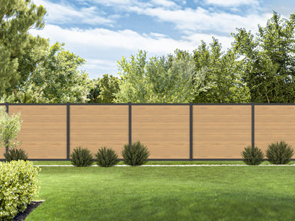 Wooden privacy fence with green grass and trees in the background